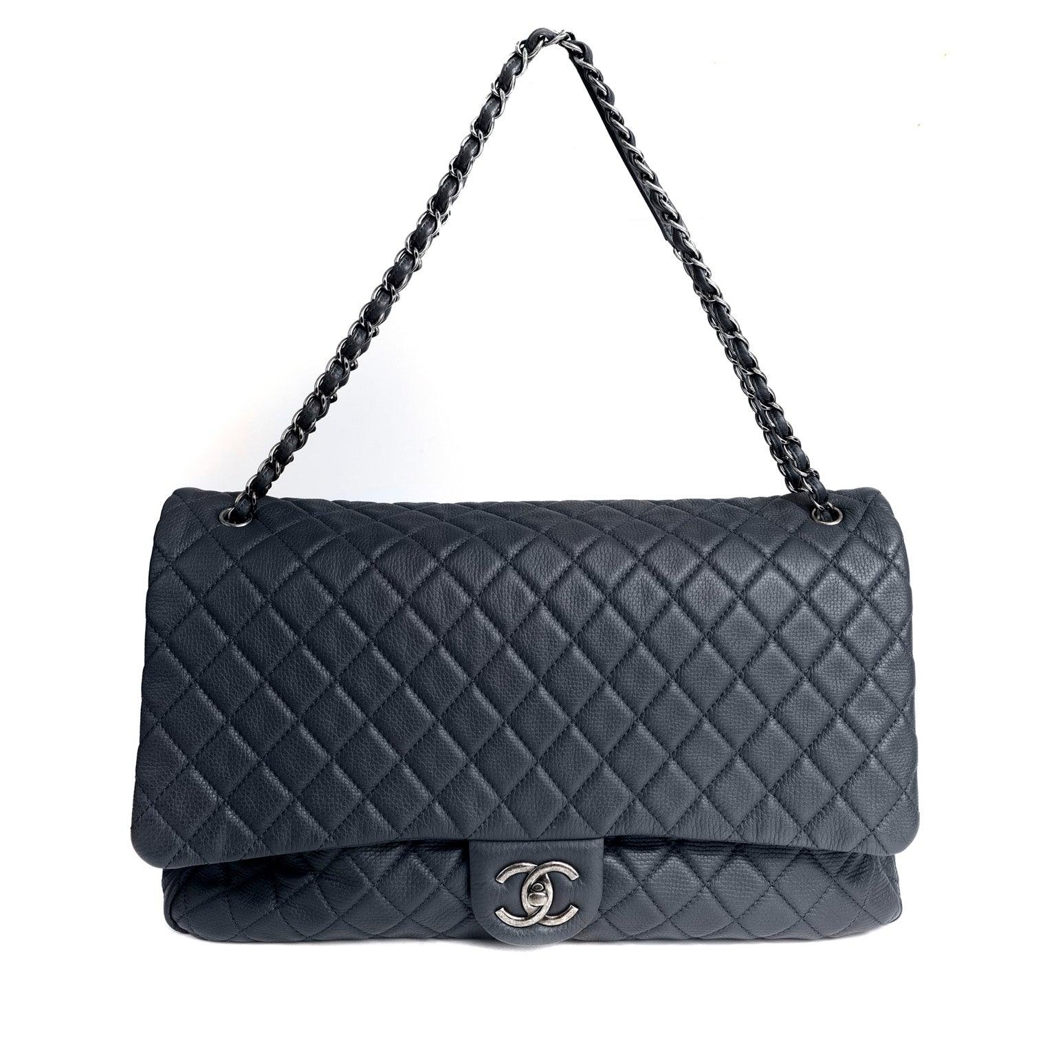 Get your hands on the stunning CHANEL NAVY XXL TRAVEL CLASSIC FLAP BAG,  made from top-quality navy lambskin leather – Only Authentics