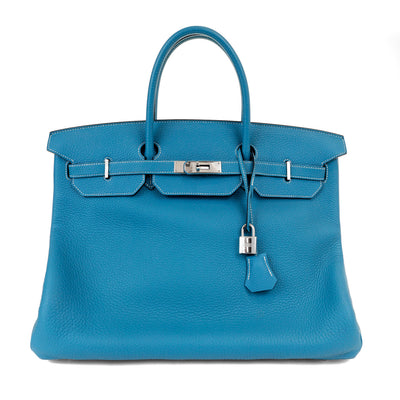 This Blue Jean Birkin by Hermès is a stunning luxury handbag that is in pristine condition. Known for their exceptional quality,