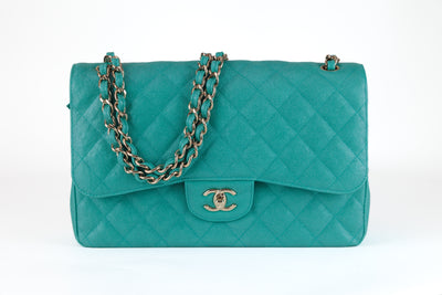 Looking for a stylish and sophisticated addition to your collection? Look no further than this authentic Chanel Iridescent Green Caviar Jumbo Classic Flap Bag