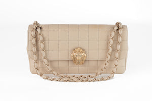 Looking for a rare and unique Chanel bag for your collection? This authentic Chanel Ivory Lambskin Chocolate Bar Quilted Flap Bag with Gold Lion Head Clasp