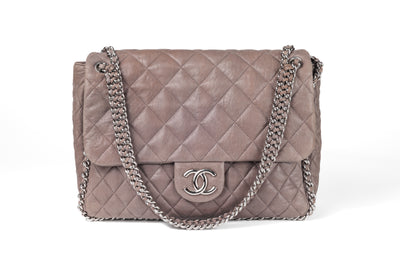 This Chanel Taupe Washed Lambskin Luxe Flap Bag is a must-have for any fashion lover